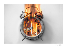 Alarm clock is burning with fire flames