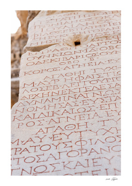 Greek writes on the marble stones of the library of Celsus
