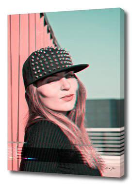Portrait of a beautiful girl in a cap with studs