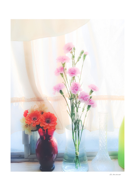 pink flowers and orange flowers with white curtain