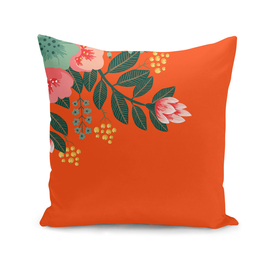 Orange accent throw pillow with tropical flowers