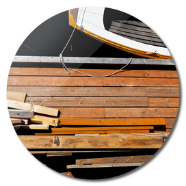 Wood on a Wooden Dock near a Wooden Boat