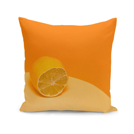 Cut fresh lemon on a yellow-orange background