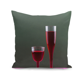 Two glasses with red wine on a colored background