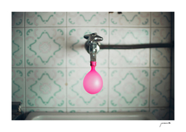 Tap with a pink balloon
