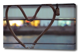 Heart-shaped padlock locked metal cables