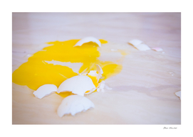 Broken egg fell on the floor is splattered with yolk