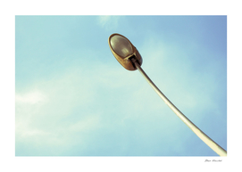 View from below of a street lamp in daylight
