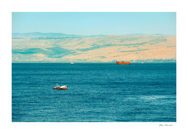 Brown wooden boat sailing in Sea of Galilee
