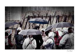 People in Rain Gear with Umbrellas