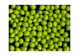 Texture and background of green peas on a black background