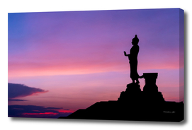 Silhouette of buddha statue with vivid sky