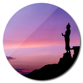 Silhouette of buddha statue with vivid sky