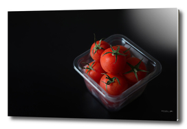 Red tomatoes in plastic box