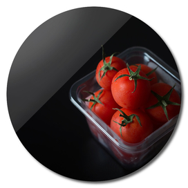 Red tomatoes in plastic box