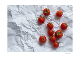 Red tomatoes on unfolded white paper