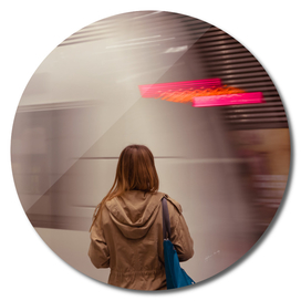 Rear View Of Young Woman Waiting For Subway. Blurred motion