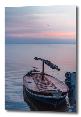 Sunset on the lake. Docked gondola boat.Fishing boat. Spain