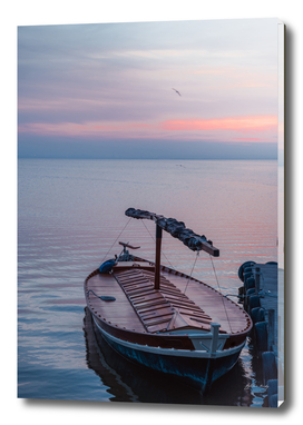Sunset on the lake. Docked gondola boat.Fishing boat. Spain