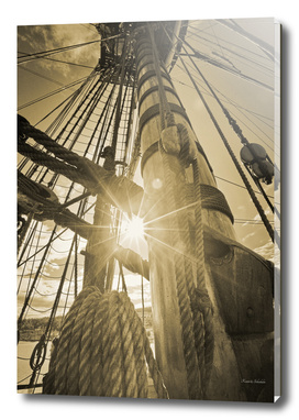 Bright sunlight shining through the rigging of a tall ship