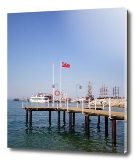 Pier with a view of the yacht (155 beach, Kemer, Turkey)