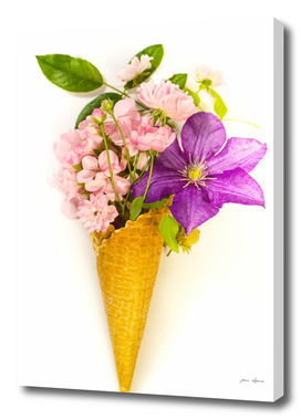 Waffle cone with   clematis, pelargonium and roses