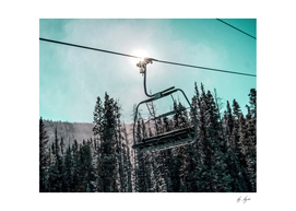 Chair Lift with Dark Blue and Teal Winter Sky