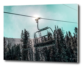 Chair Lift with Dark Blue and Teal Winter Sky