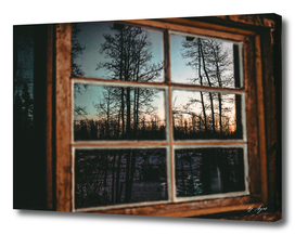 Grainy Sunset Reflection on Log Cabin Window