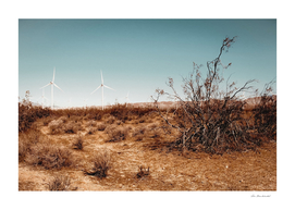 Desert and wind turbine with blue sky