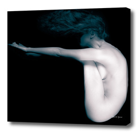 Naked woman in studio seating upsidedown in black and white