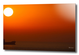 Orange Sunset over the Ocean with one ship