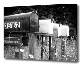 Black and white row of old road country mailboxes