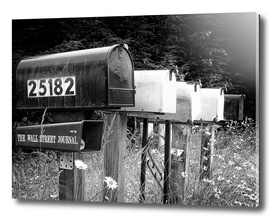 Black and white row of old road country mailboxes
