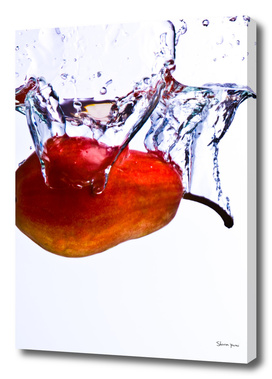 Pear falls into water with a splash on white background