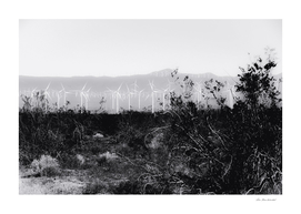 wind turbine with desert view in black and white