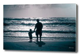 Father and Son on the beach at dusk