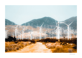 Wind turbine in the desert with mountain background