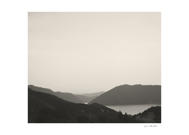 Black and white minimalist landscape mountains and a lake