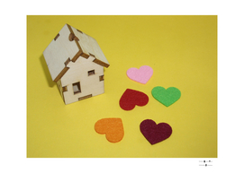 Multicolored hearts lie near the wooden house