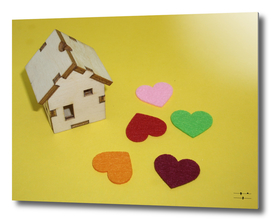 Multicolored hearts lie near the wooden house