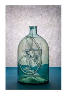 Still life with a transparent glass bottle