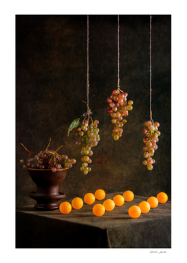 Still life with grapes and orange balls
