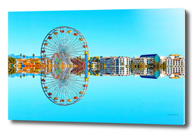 reflection of the ferris wheel with buildings and blue sky