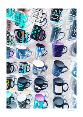 colorful mugs hanging on the white wall