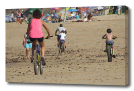 biking Family on the beach at Sea
