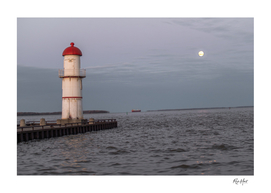 Moon over the lake with light house