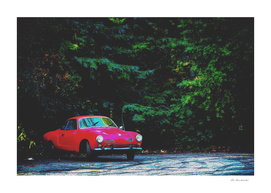 red classic car in the forest with green tree background
