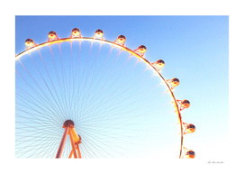 orange Ferris Wheel in the city with blue sky