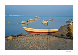 Photo of boats in bay at sunset in Portugal